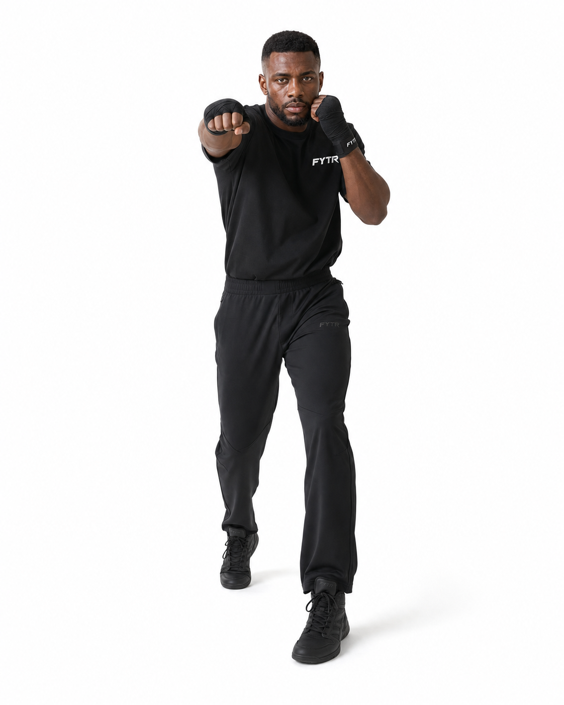 FYTR athlete jabbing on a white studio background in the Black Core Training T-Shirt and black hand wraps