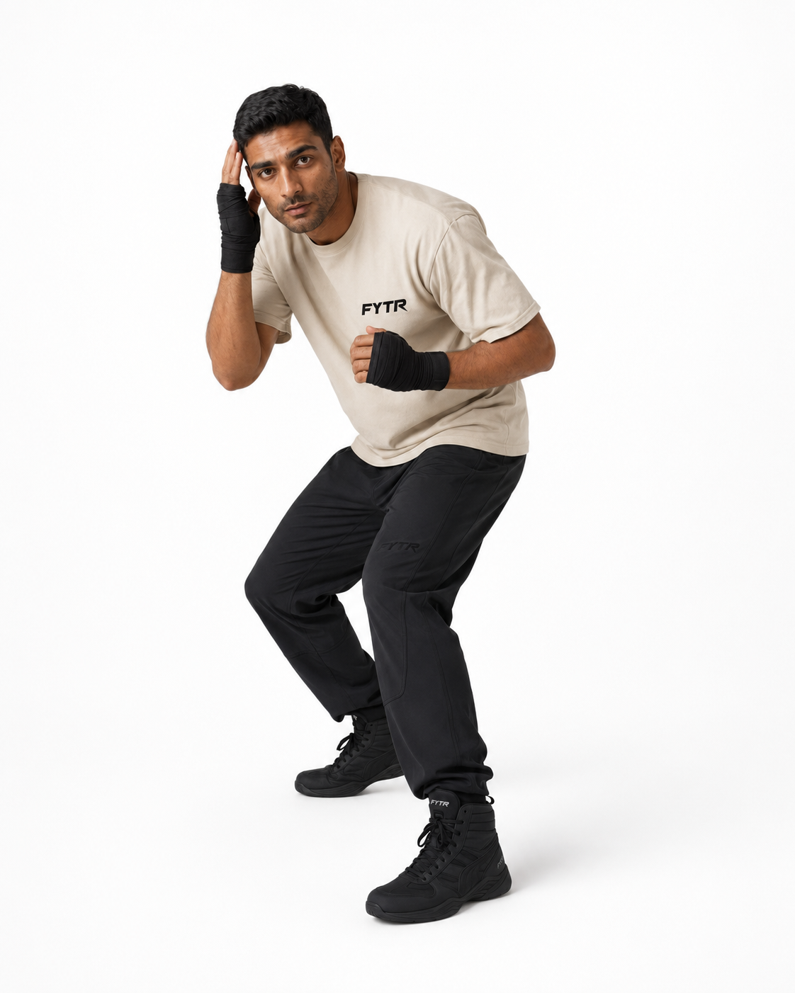 FYTR athlete slipping on a white studio background in the Natural Core Training T-Shirt and black hand wraps