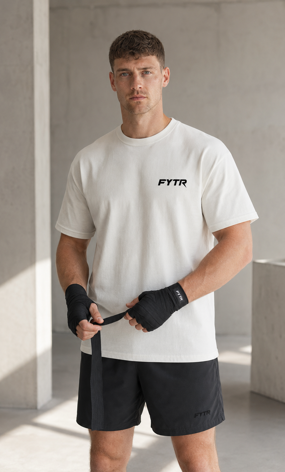 Model wearing the FYTR Core T-Shirt in Off White in a boxing stance