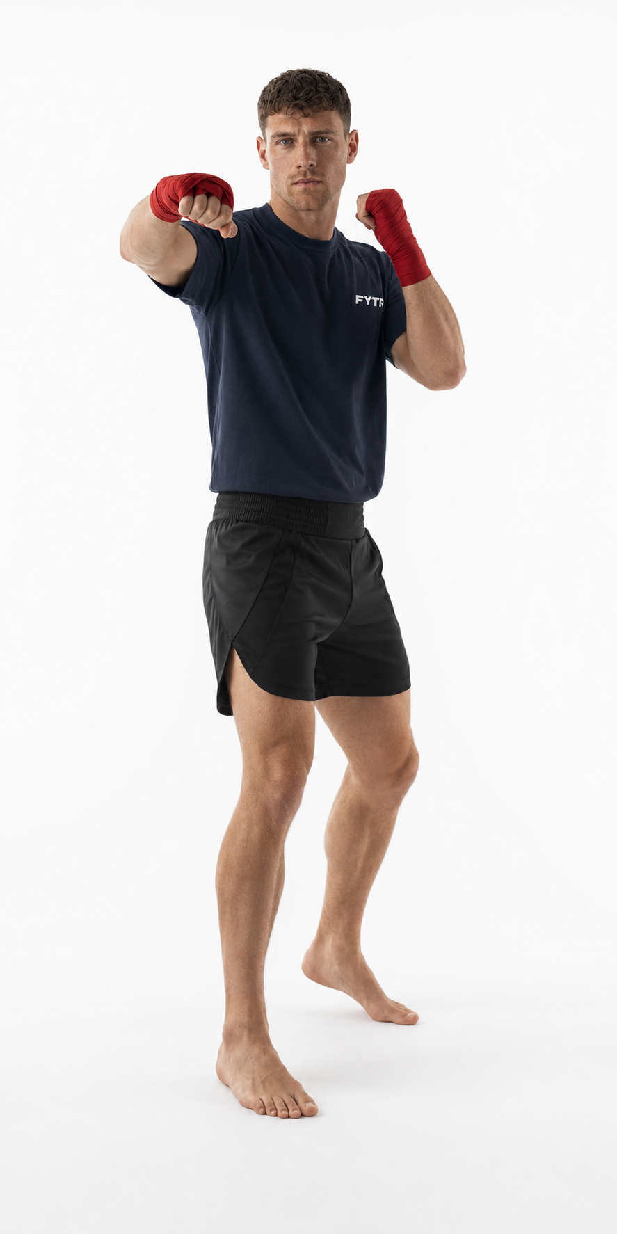FYTR athlete throwing a cross on a white studio background in the Washed Navy Core Training T-Shirt and red hand wraps